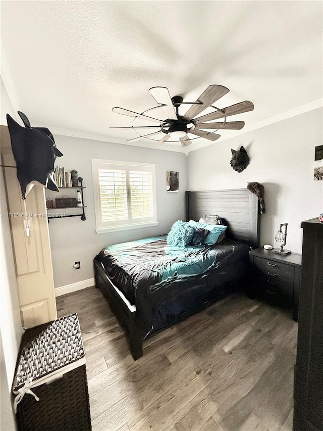 bedroom with ceiling fan, hardwood / wood-style floors, a textured ceiling, and ornamental molding