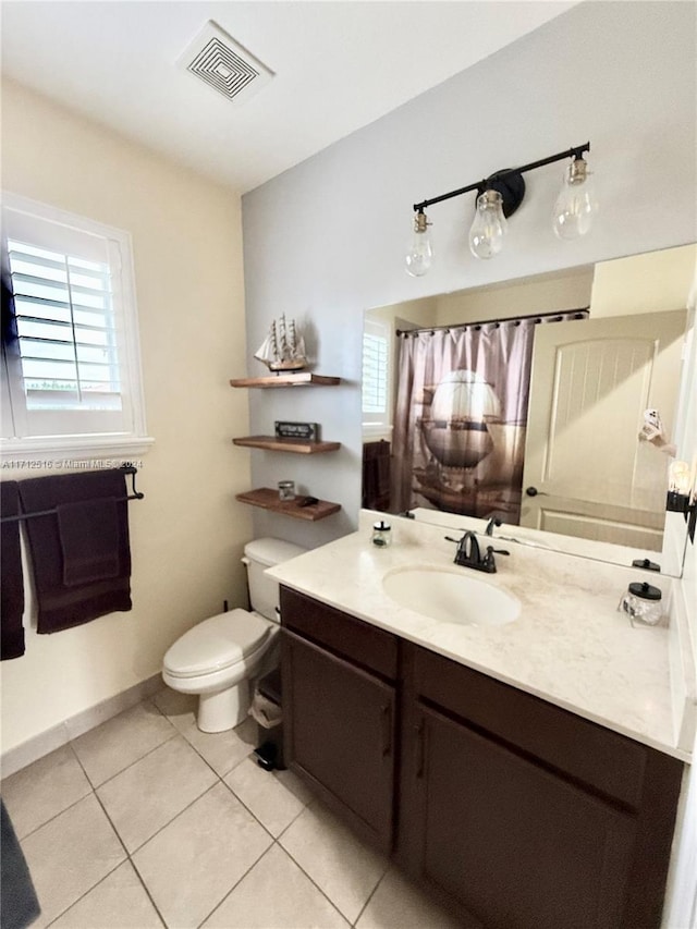 bathroom featuring tile patterned floors, vanity, and toilet