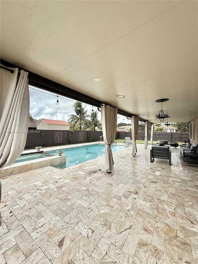 view of swimming pool with an in ground hot tub and a patio