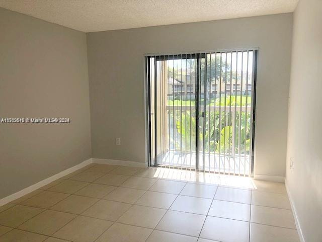 5200 NW 31st Ave Unit 155, Fort Lauderdale, FL 33309 - spare room with a textured ceiling and tile patterned floors