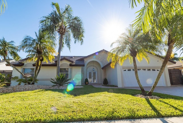 single story home featuring french doors, a front yard, and a garage