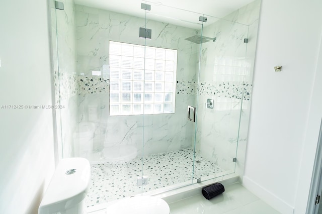 bathroom featuring tile patterned flooring, toilet, and a shower with shower door