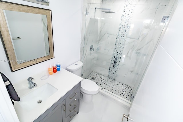 bathroom featuring vanity, toilet, and a shower with shower door