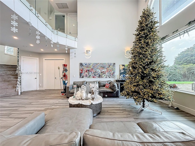 living room featuring light hardwood / wood-style floors and a high ceiling