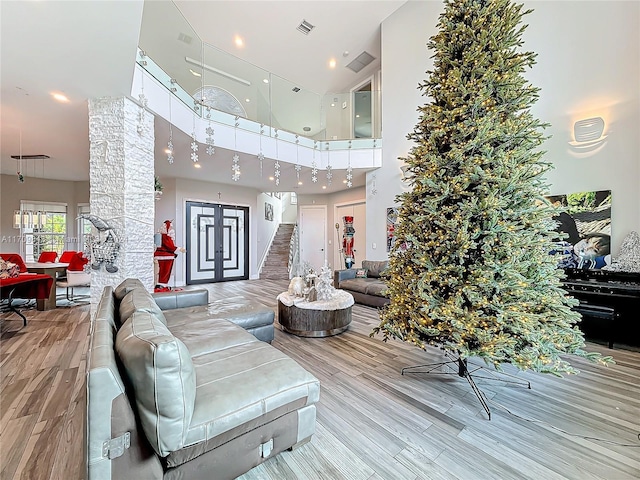 living room featuring hardwood / wood-style floors and a towering ceiling