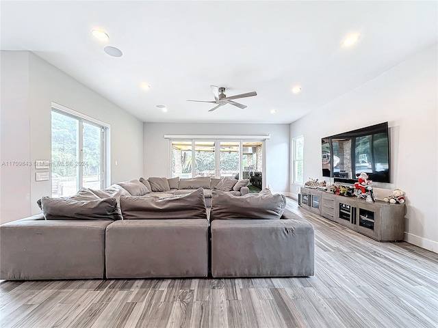 living room featuring ceiling fan, french doors, and light hardwood / wood-style floors