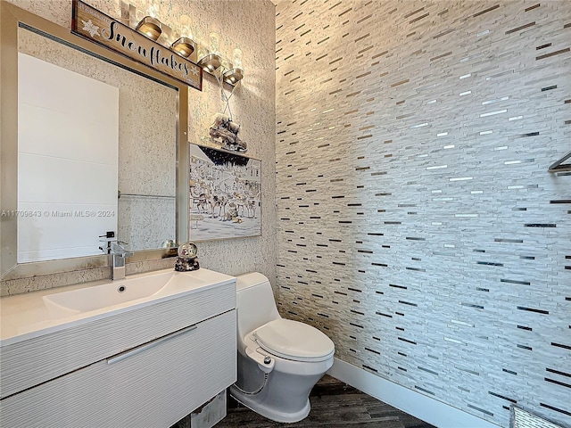 bathroom featuring hardwood / wood-style floors, vanity, and toilet