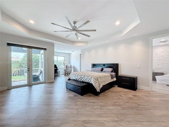 bedroom with access to outside, french doors, a raised ceiling, ceiling fan, and light hardwood / wood-style floors