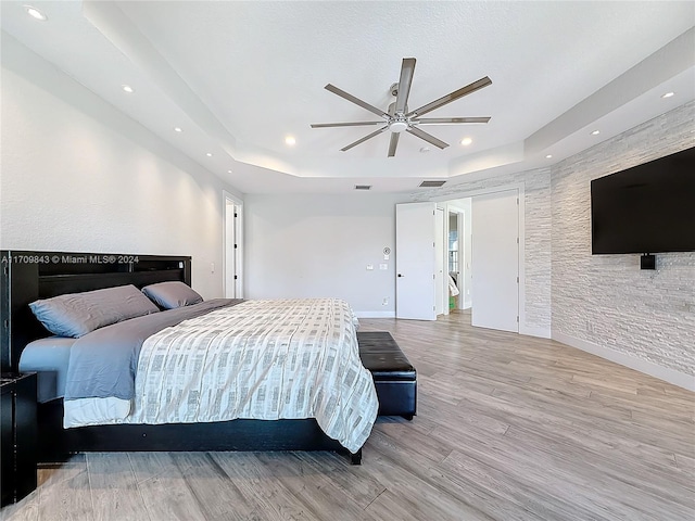 bedroom with light hardwood / wood-style flooring and ceiling fan