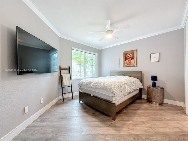 bedroom with ceiling fan, light wood-type flooring, and crown molding