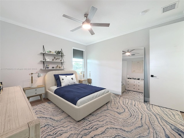 carpeted bedroom with ceiling fan and ornamental molding