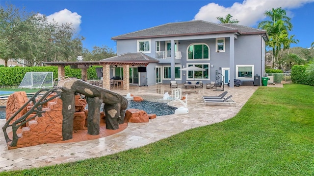 rear view of house featuring a lawn, a balcony, a patio, and pool water feature