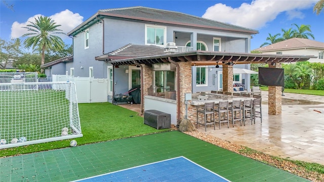 rear view of house with an outdoor bar and a patio