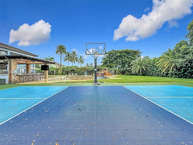 view of basketball court with a yard