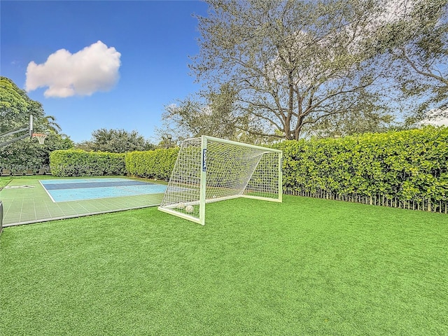 view of yard featuring basketball court