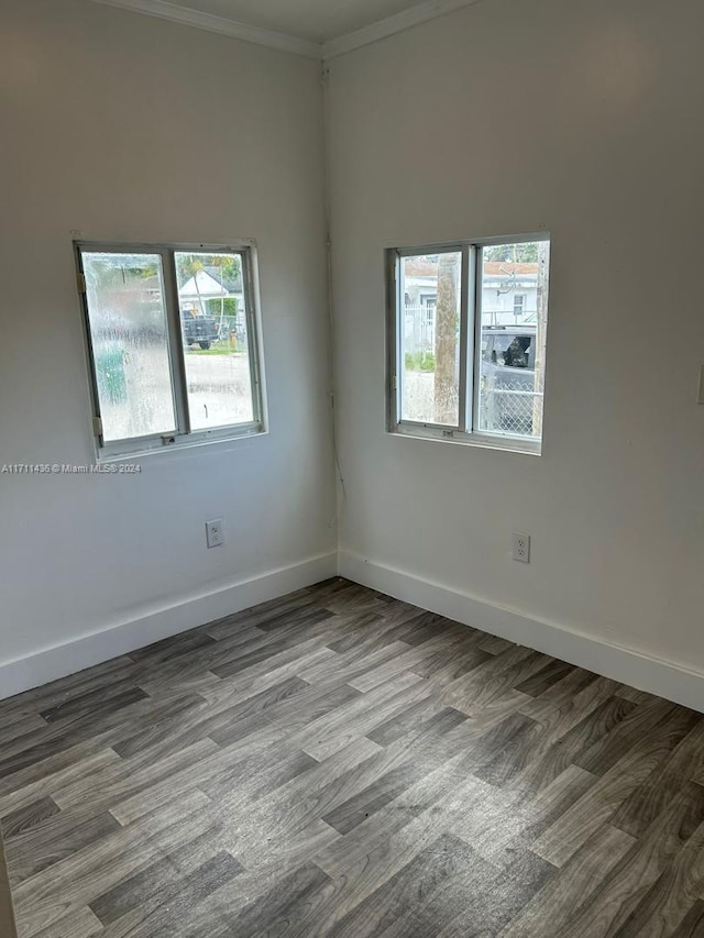 empty room with crown molding and hardwood / wood-style floors