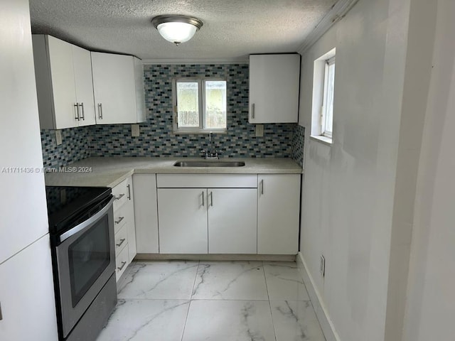 kitchen featuring stainless steel range with electric stovetop, sink, decorative backsplash, a textured ceiling, and white cabinetry