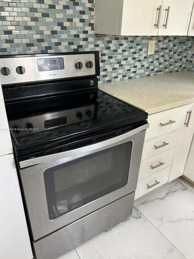 kitchen with decorative backsplash and stainless steel range with electric cooktop