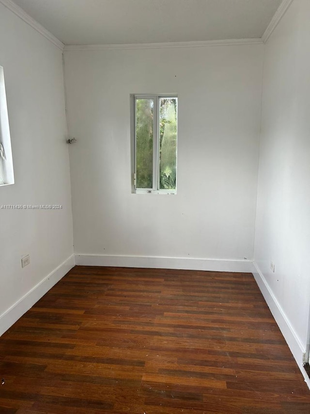 unfurnished room featuring dark hardwood / wood-style floors and ornamental molding