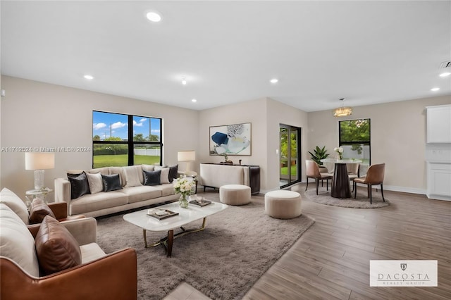 living room featuring a chandelier and light hardwood / wood-style floors