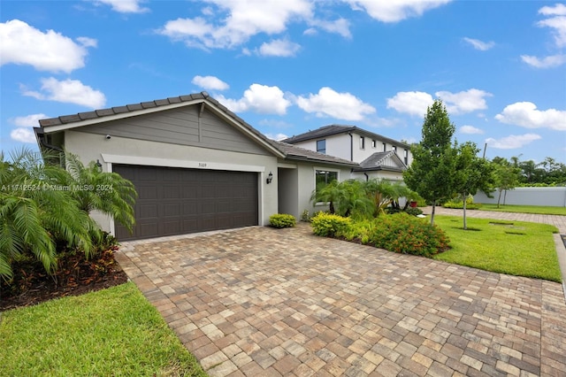 view of front facade featuring a front yard and a garage