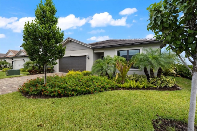 view of front of property featuring a garage and a front lawn