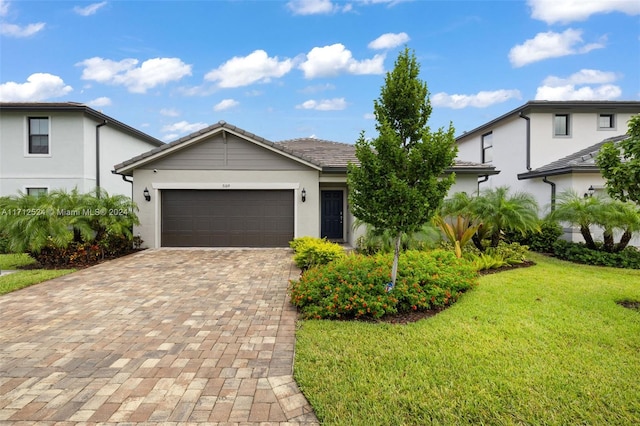 view of front facade with a front yard and a garage