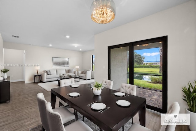 dining area featuring hardwood / wood-style flooring and a chandelier