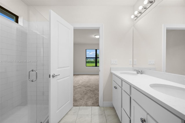 bathroom with tile patterned flooring, vanity, and a shower with door