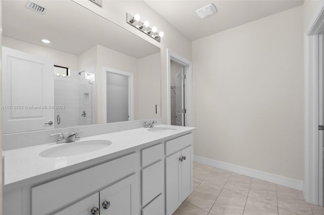 bathroom with tile patterned flooring, vanity, and an enclosed shower