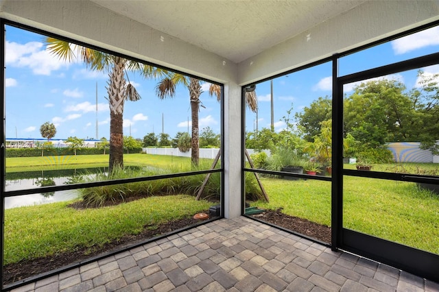 unfurnished sunroom with a water view