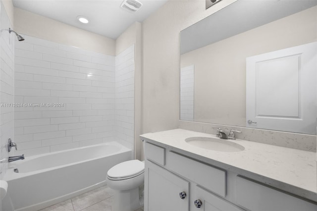 full bathroom featuring tile patterned flooring, tiled shower / bath combo, toilet, and vanity