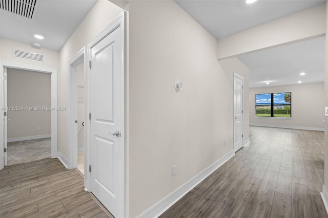 corridor featuring hardwood / wood-style floors