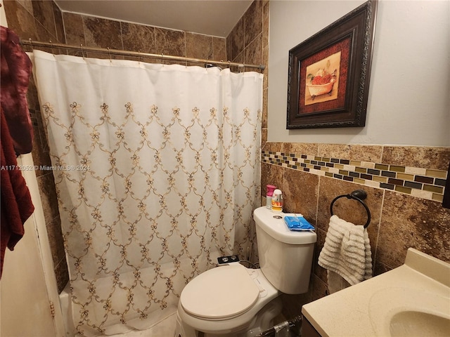 bathroom with vanity, tile walls, and toilet