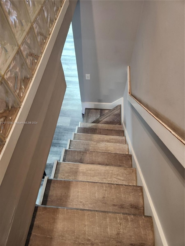 stairway with hardwood / wood-style floors