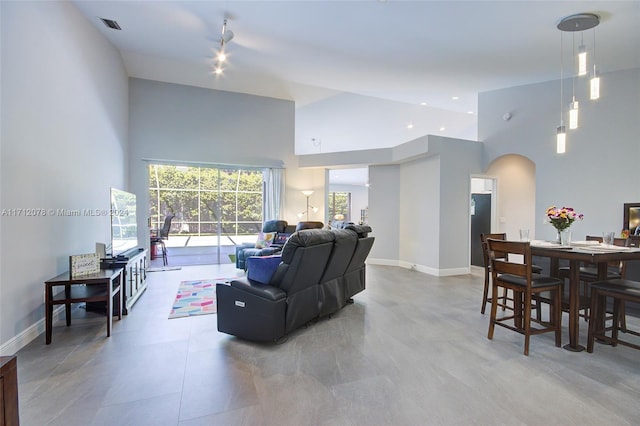 living room featuring high vaulted ceiling