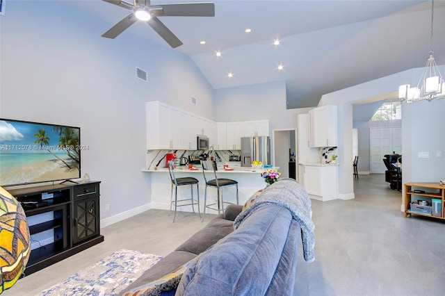 living room featuring high vaulted ceiling and ceiling fan