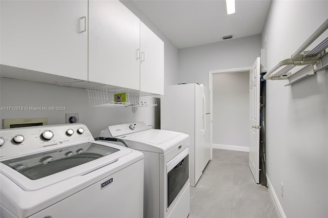 laundry room with cabinets and separate washer and dryer