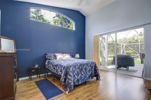 bedroom featuring multiple windows, light hardwood / wood-style flooring, and access to exterior