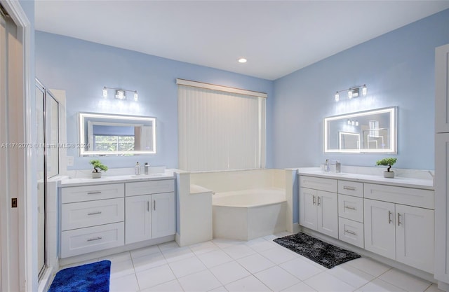 bathroom featuring tile patterned flooring, vanity, and shower with separate bathtub