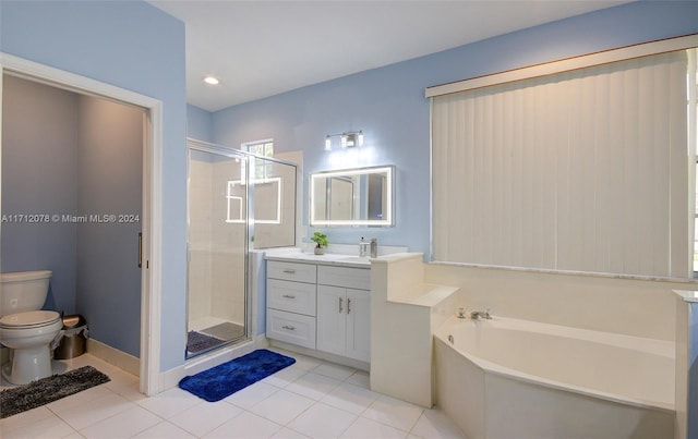 full bathroom featuring plus walk in shower, vanity, toilet, and tile patterned flooring