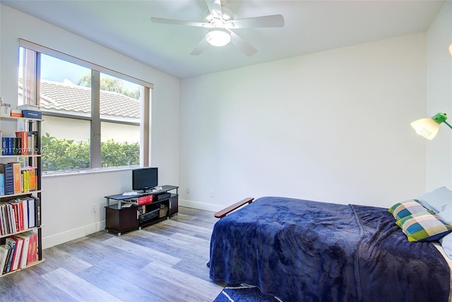 bedroom with ceiling fan and light hardwood / wood-style floors