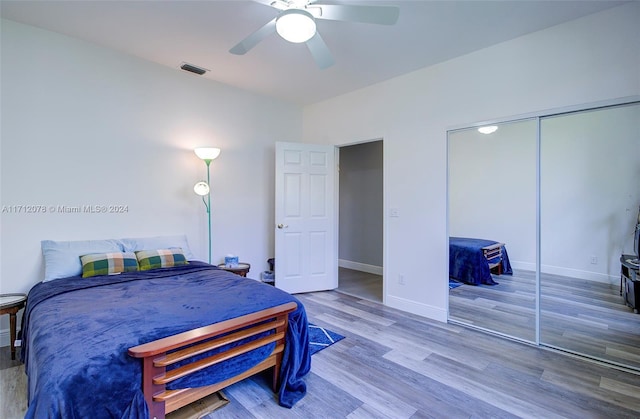 bedroom featuring wood-type flooring, a closet, and ceiling fan