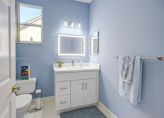 bathroom featuring tile patterned flooring, vanity, and toilet