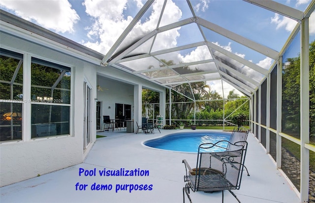 view of pool with glass enclosure, ceiling fan, and a patio