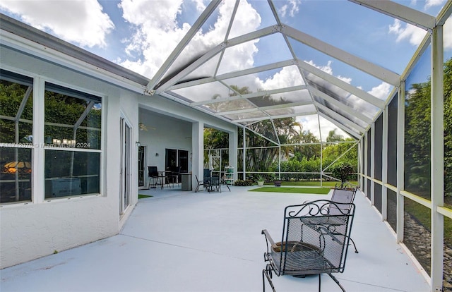 view of patio / terrace featuring ceiling fan and a lanai