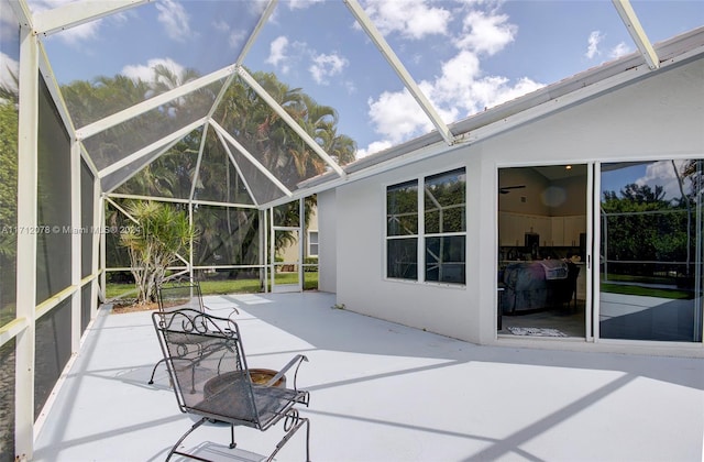 sunroom featuring plenty of natural light and vaulted ceiling