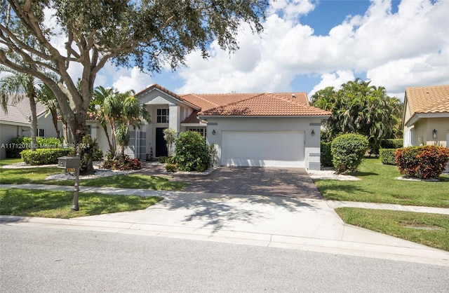 mediterranean / spanish-style house with a garage and a front yard