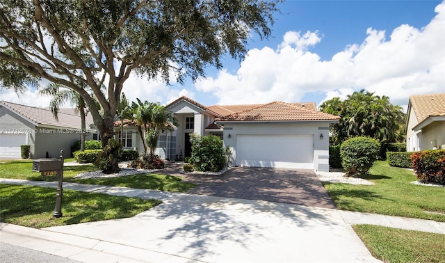 mediterranean / spanish house with a garage and a front yard