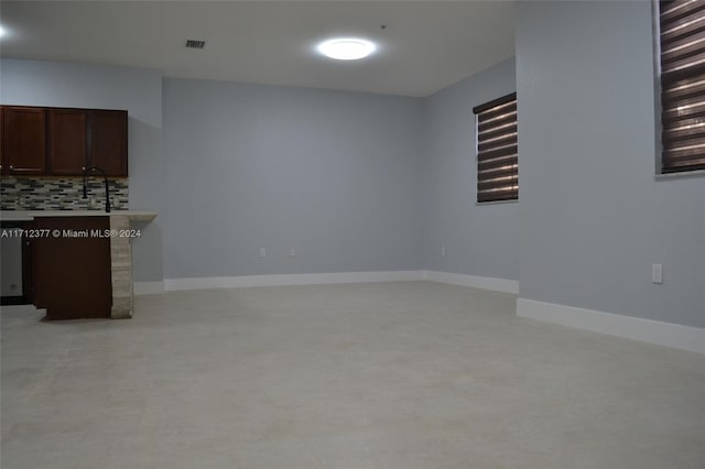 unfurnished living room featuring sink